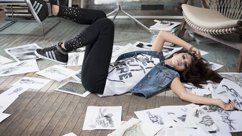 woman lying on floor with sketches