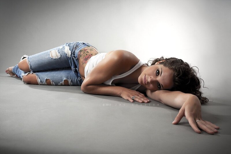 woman lying on floor with tattoo