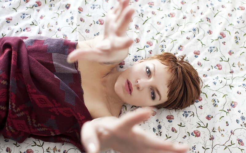 woman lying on floral bed