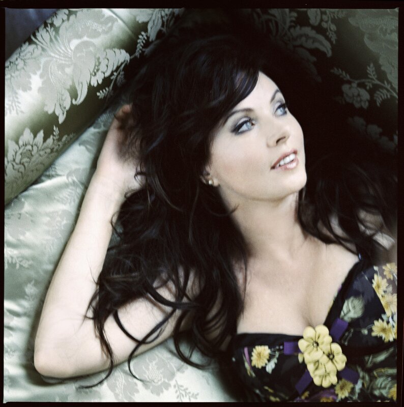 woman lying on floral couch