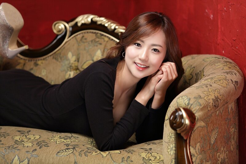 woman lying on floral couch