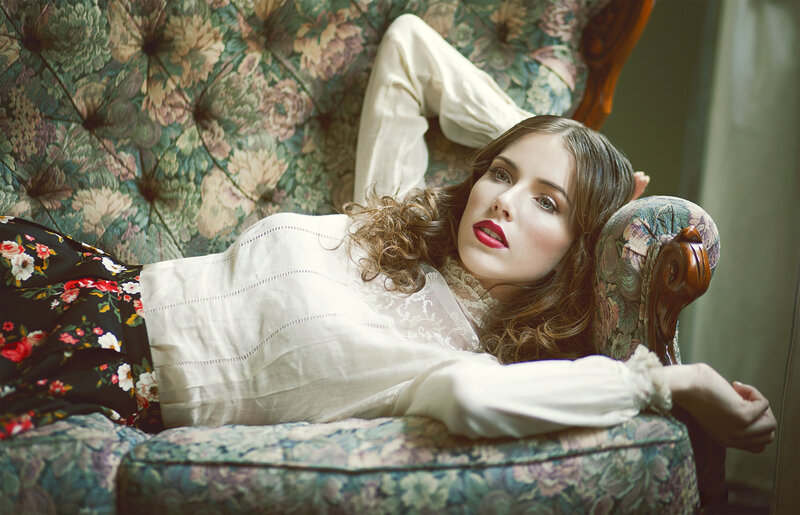 Woman Lying on Floral Couch — White