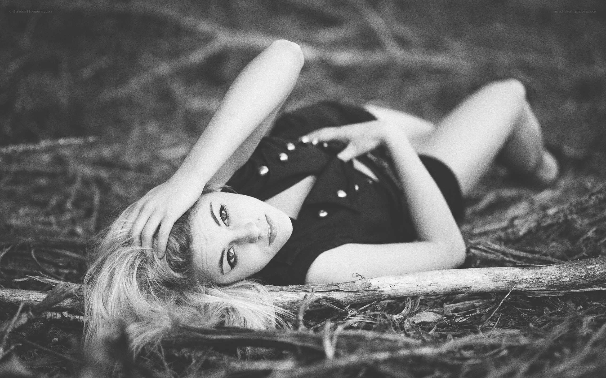 woman lying on forest floor