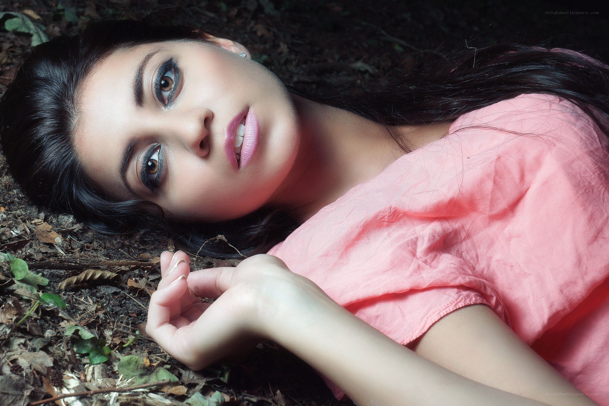 woman lying on forest floor