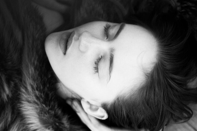 Woman Lying on Fur — Black, Serene