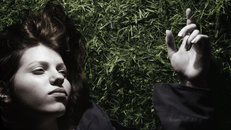 woman lying on grass