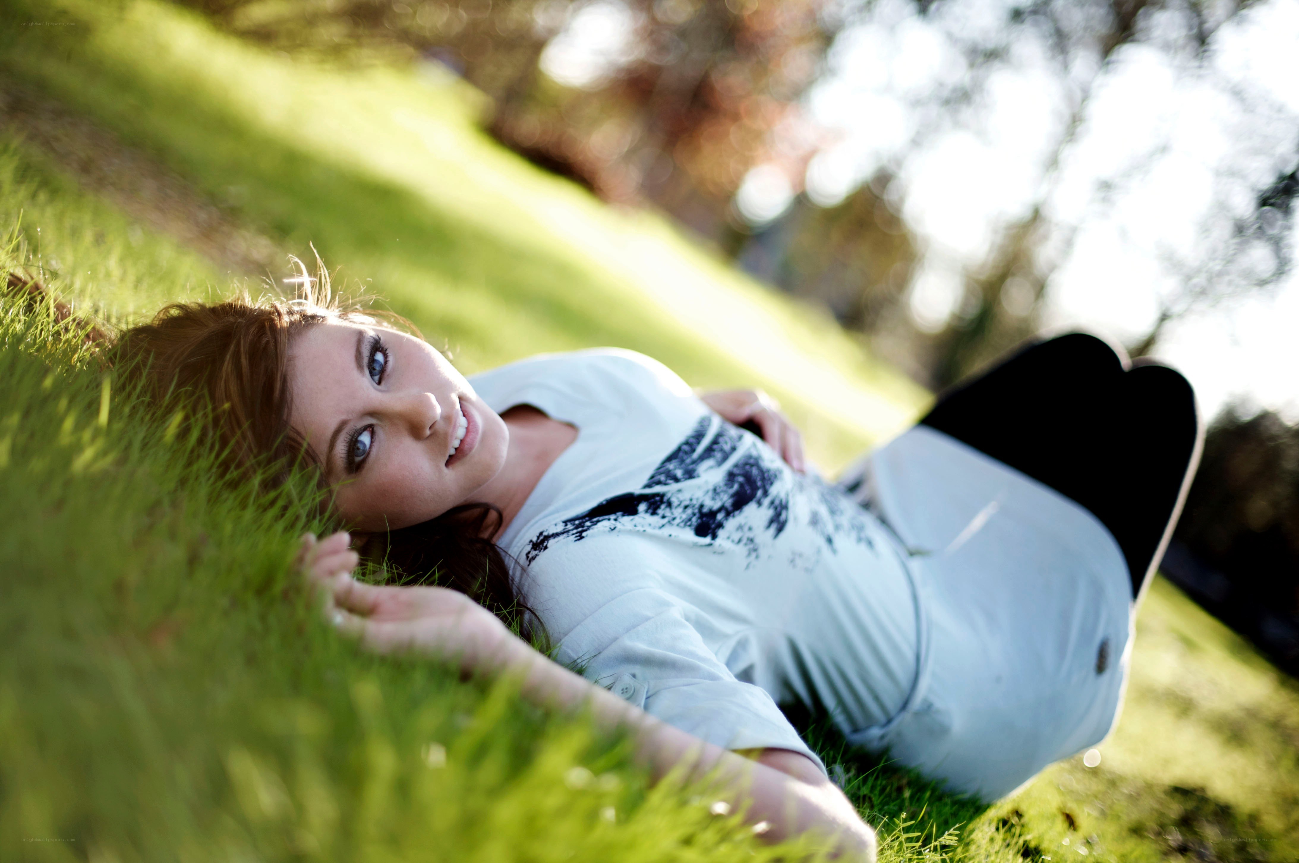 woman lying on grass