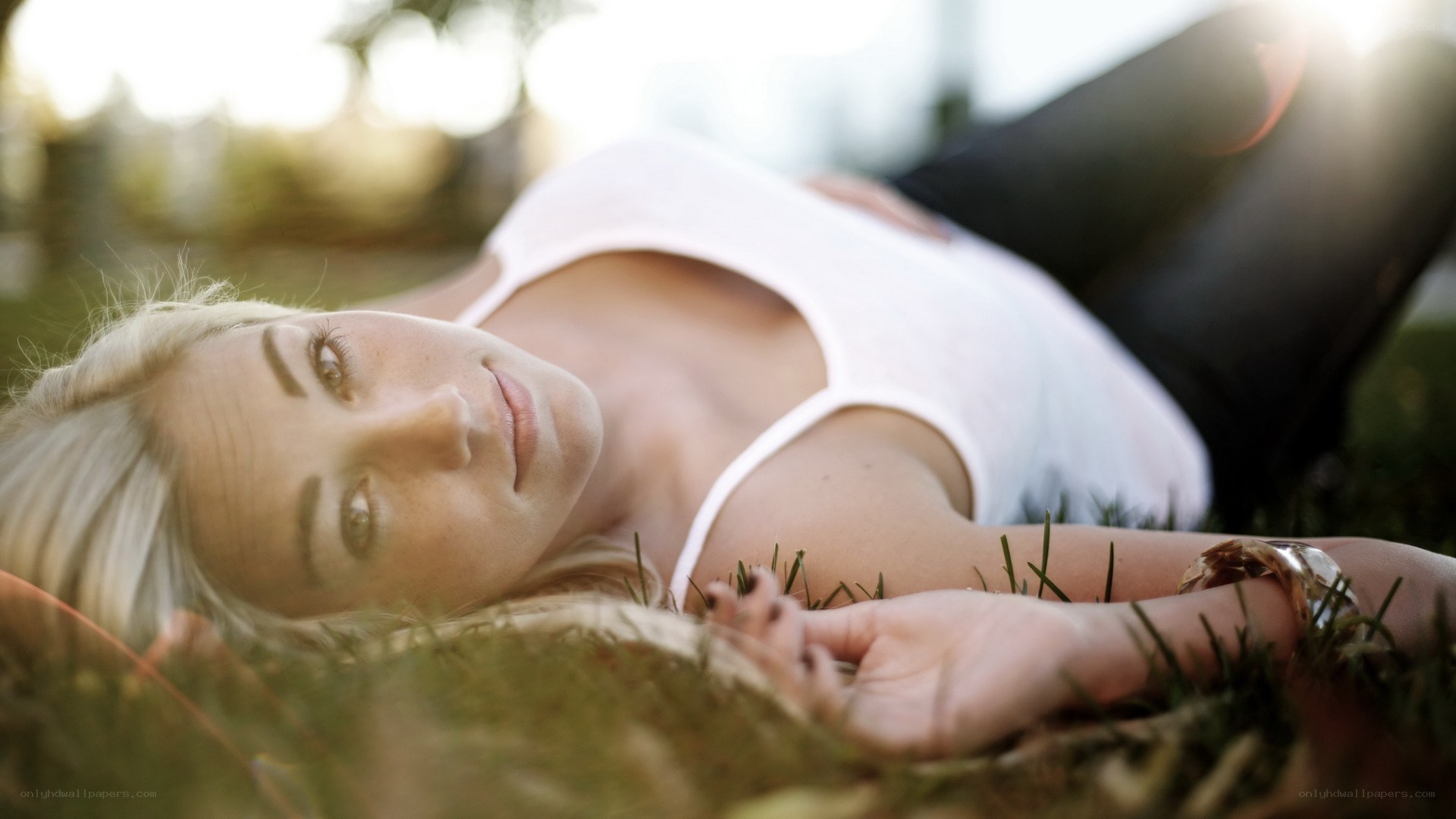 woman lying on grass at sunset