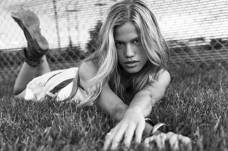 Woman Lying on Grass — Black, Serious