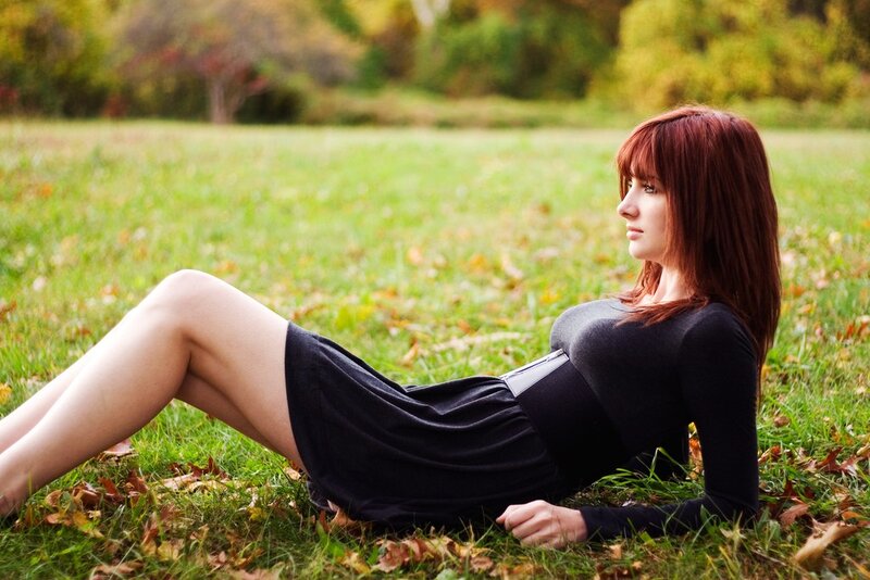 Woman lying on grass in autumn