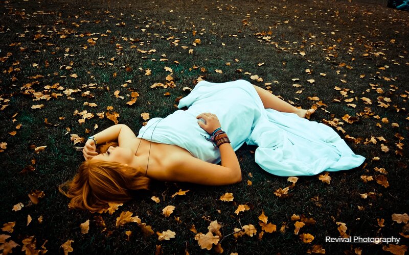 Woman lying on grass in autumn