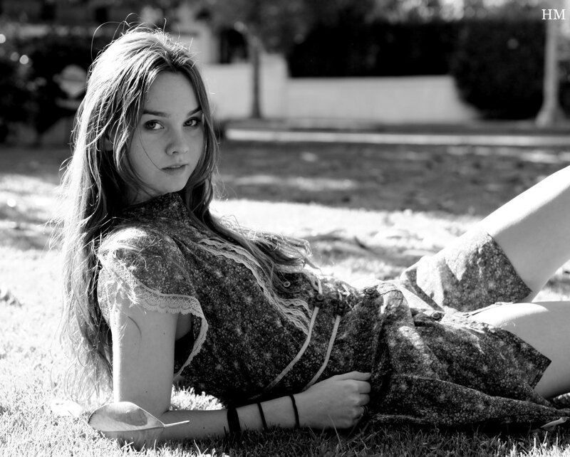 woman lying on grass in black and white