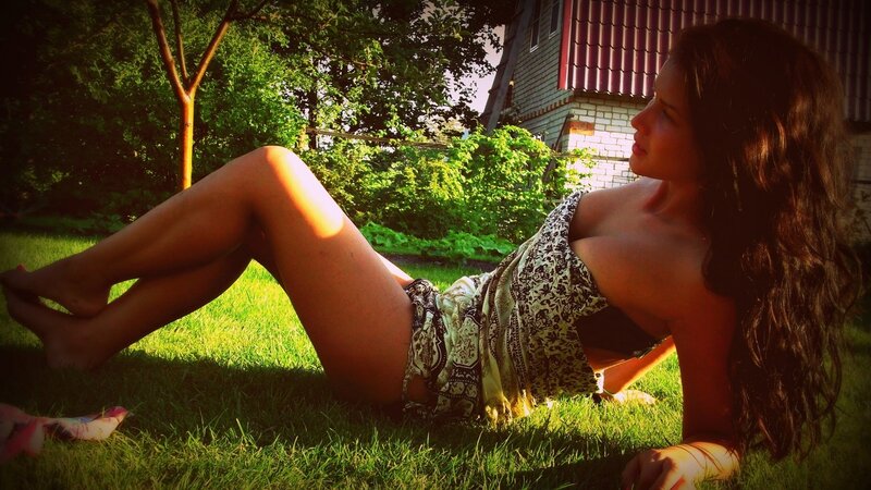 woman lying on grass in garden