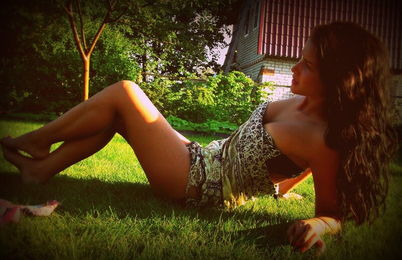 woman lying on grass in garden