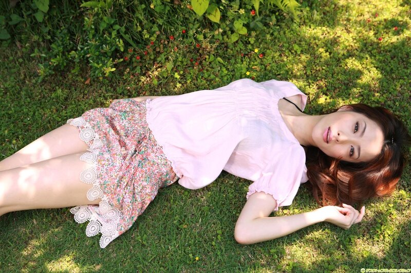 Woman lying on grass in garden