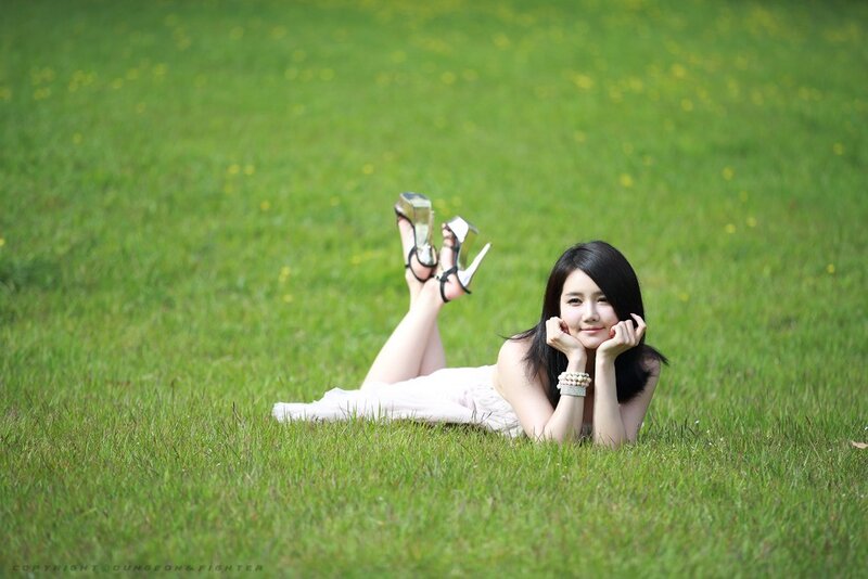 Woman lying on grass in heels