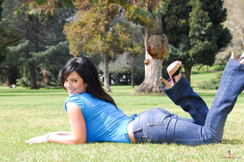 Woman lying on grass in park