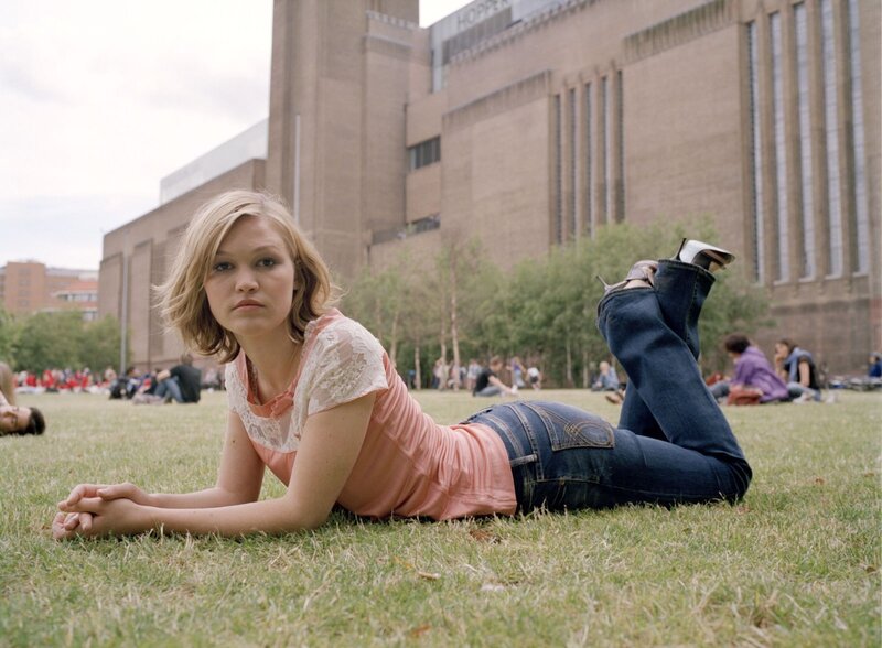 Woman lying on grass in park