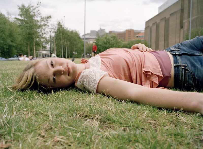 Woman lying on grass in park