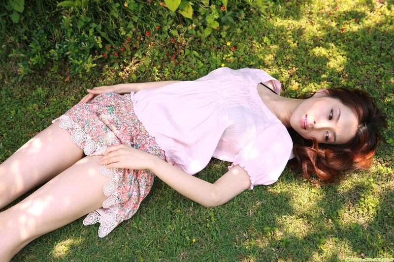 Woman lying on grass in summer