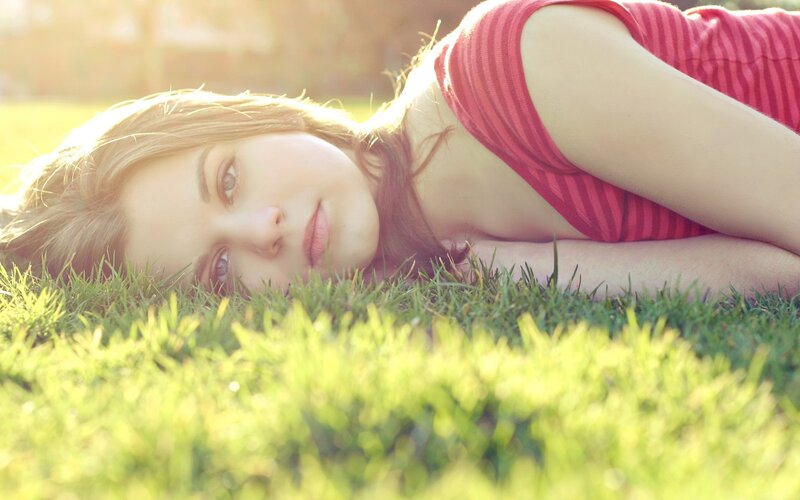 woman lying on grass in sunlight