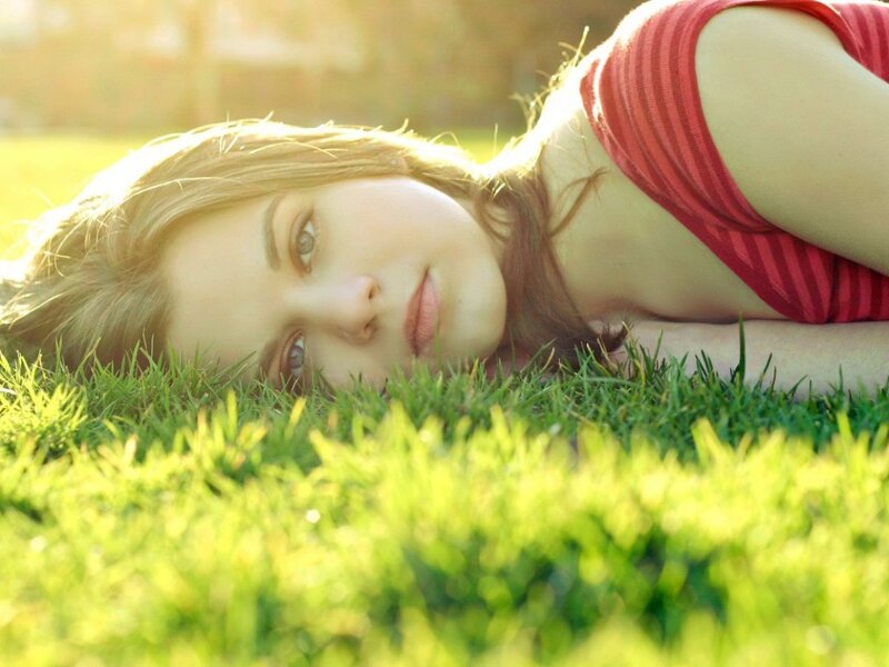 woman lying on grass in sunlight