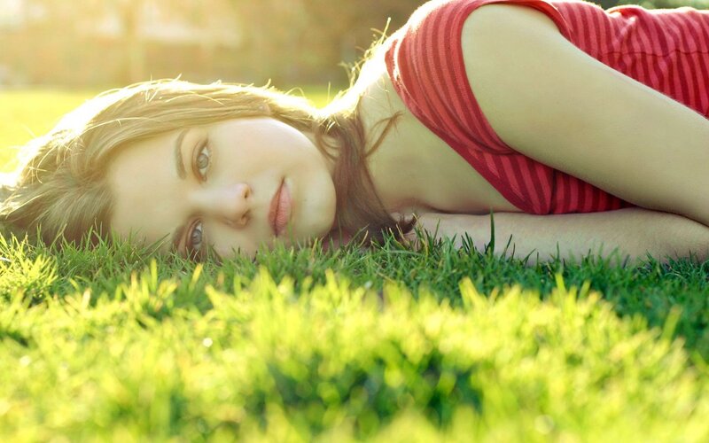 woman lying on grass in sunlight
