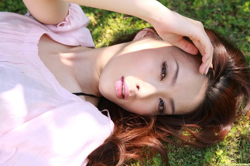 woman lying on grass in sunlight