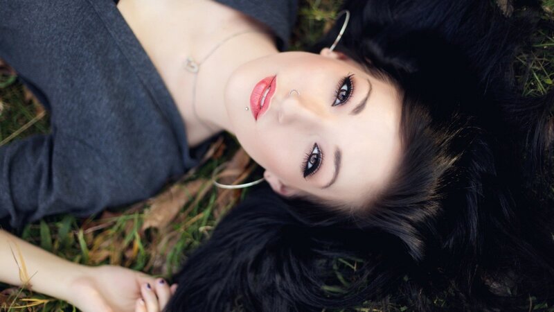 woman lying on grass looking up