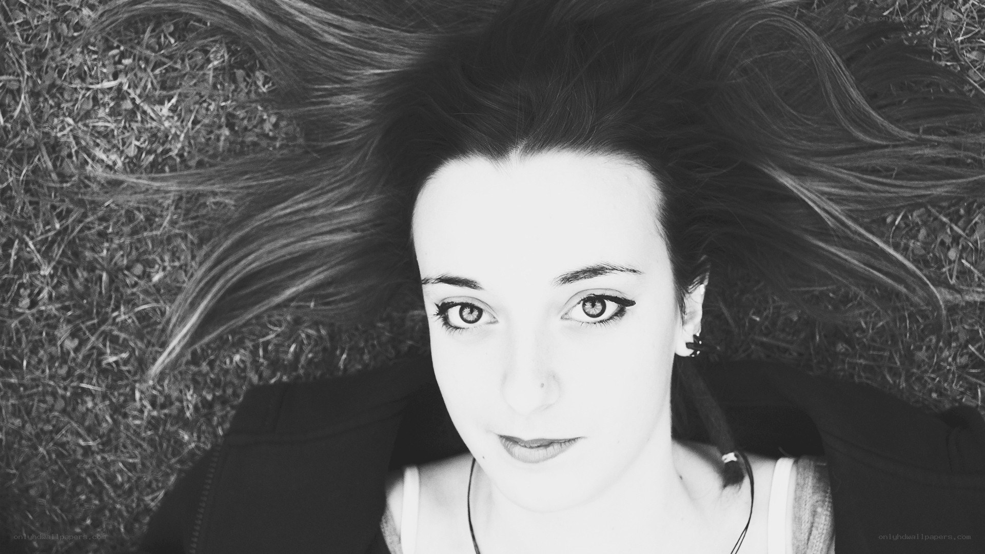 woman lying on grass looking up
