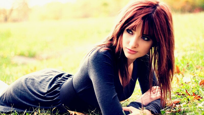 woman lying on grass outdoors