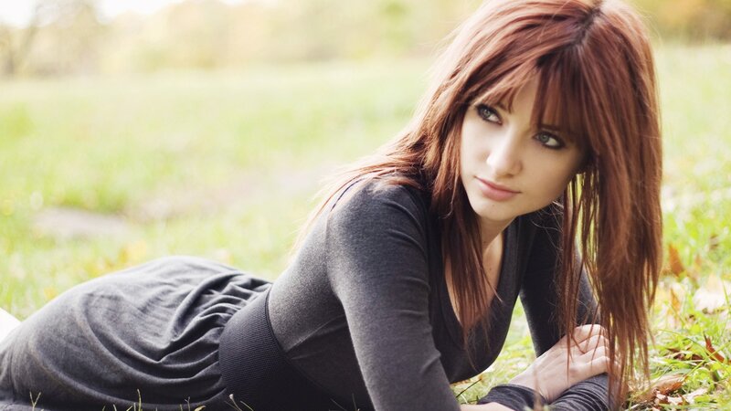 woman lying on grass outdoors