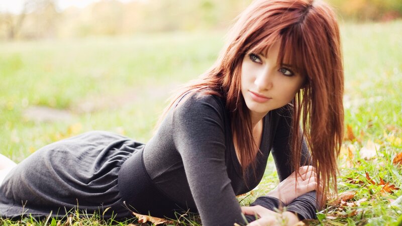 woman lying on grass outdoors
