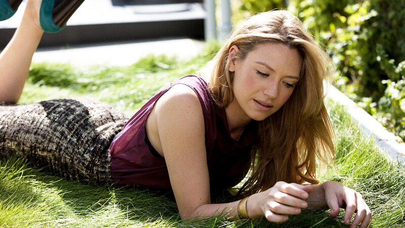 woman lying on grass outdoors