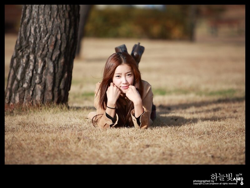 woman lying on grass outdoors