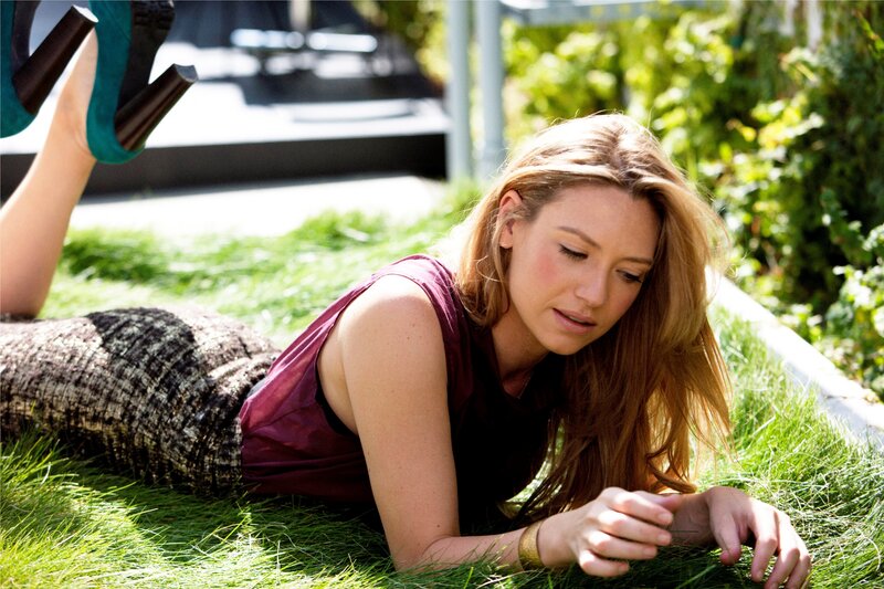 woman lying on grass outdoors