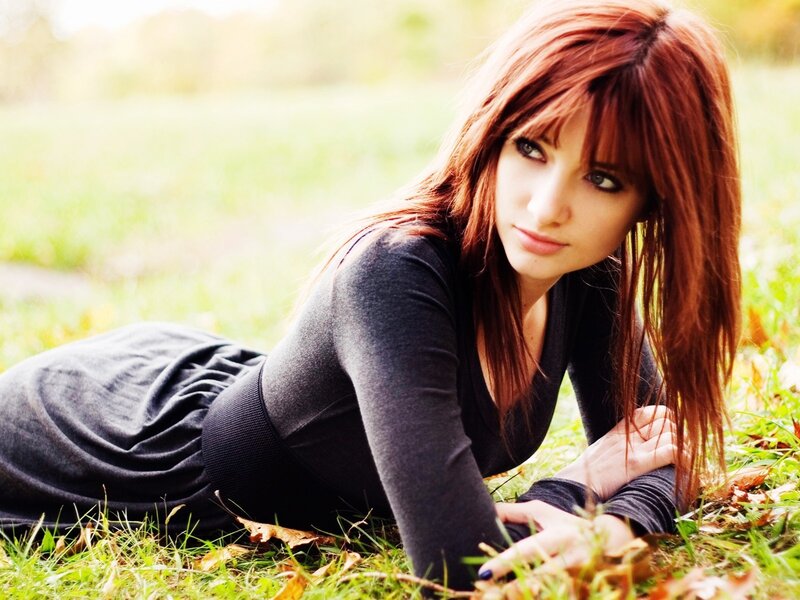 woman lying on grass outdoors