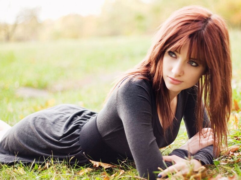 woman lying on grass outdoors