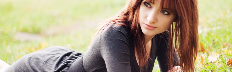 woman lying on grass outdoors
