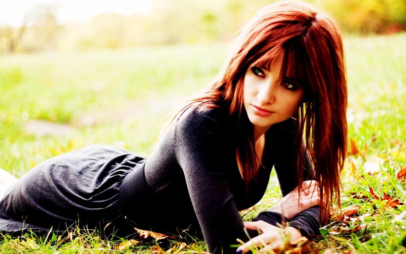 woman lying on grass outdoors