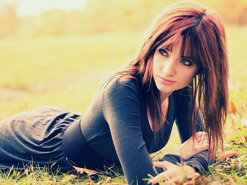 woman lying on grass outdoors