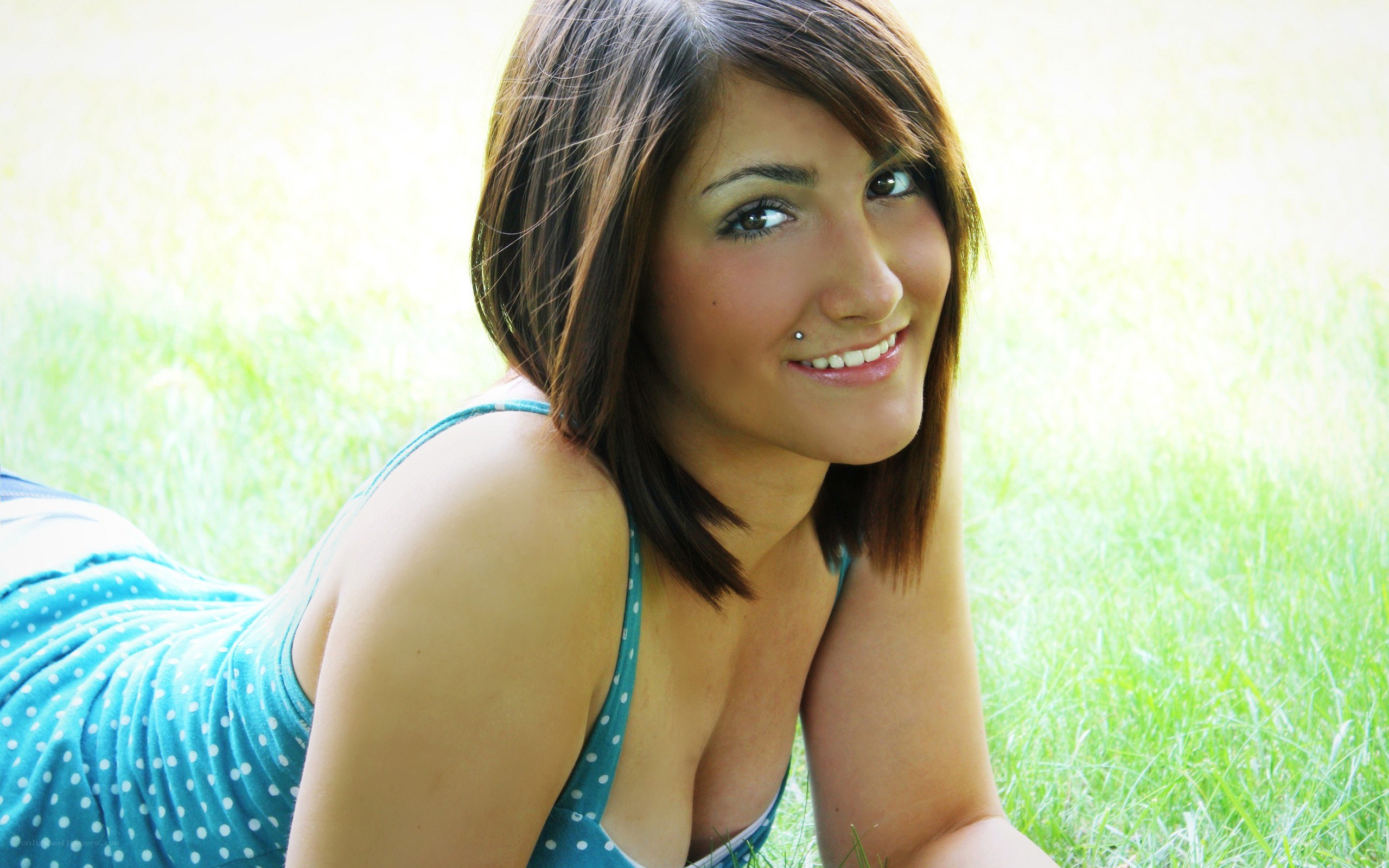 woman lying on grass smiling