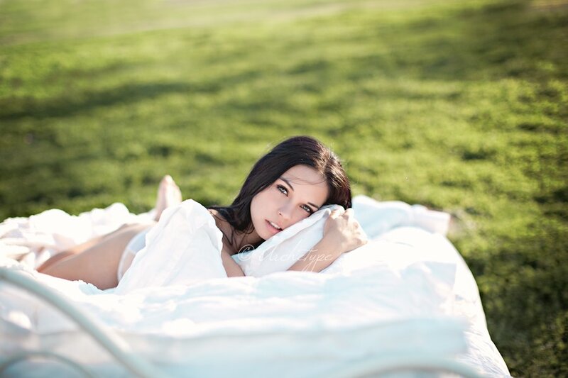 woman lying on grass with blanket