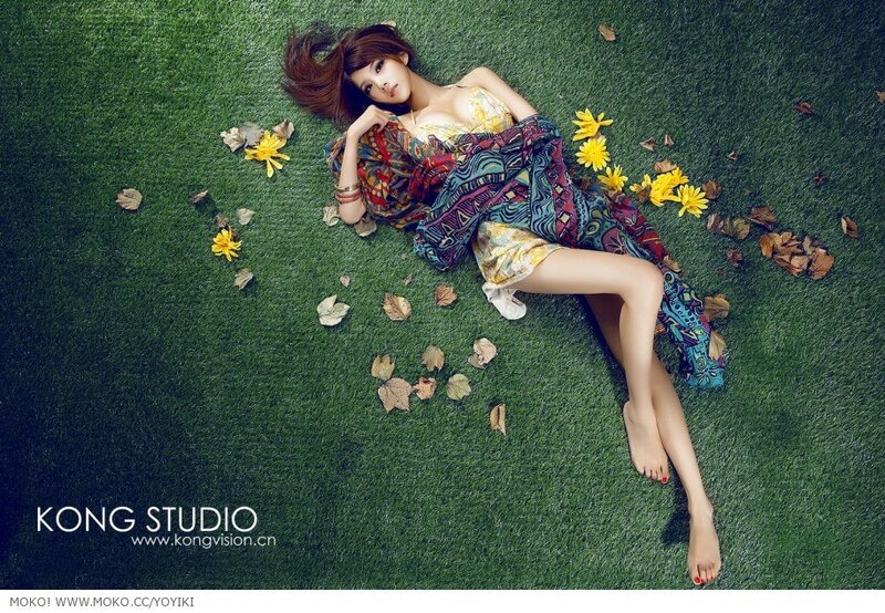 woman lying on grass with flowers