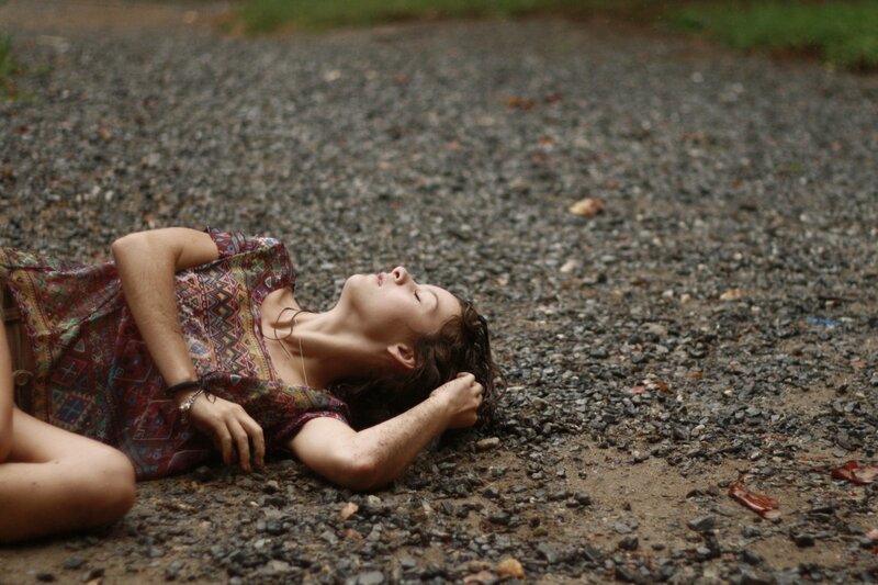 woman lying on gravel path