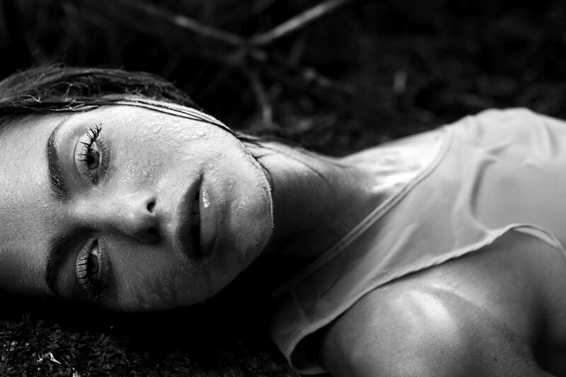 Woman Lying on Ground — Black, Dramatic, Photograph, Wet Skin