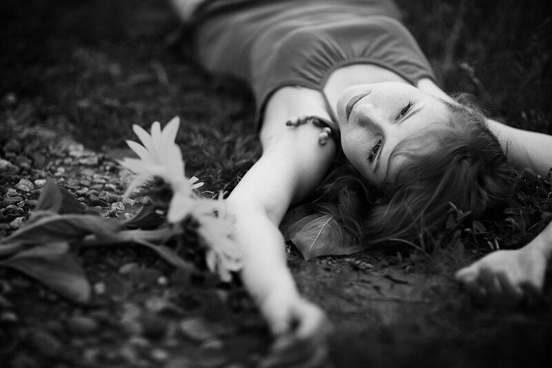 Woman Lying on Ground — Black, Serene, Photograph, Flower