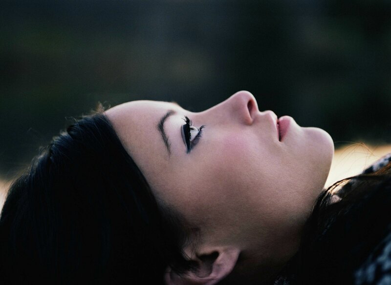 Woman Lying on Ground — Black, Serene, Sunset