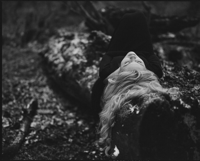 Woman Lying on Ground — Black, Serene