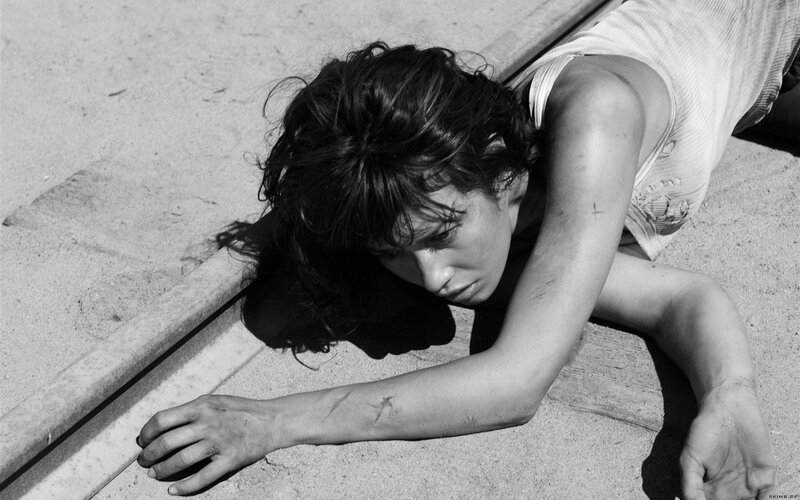 woman lying on ground in distress